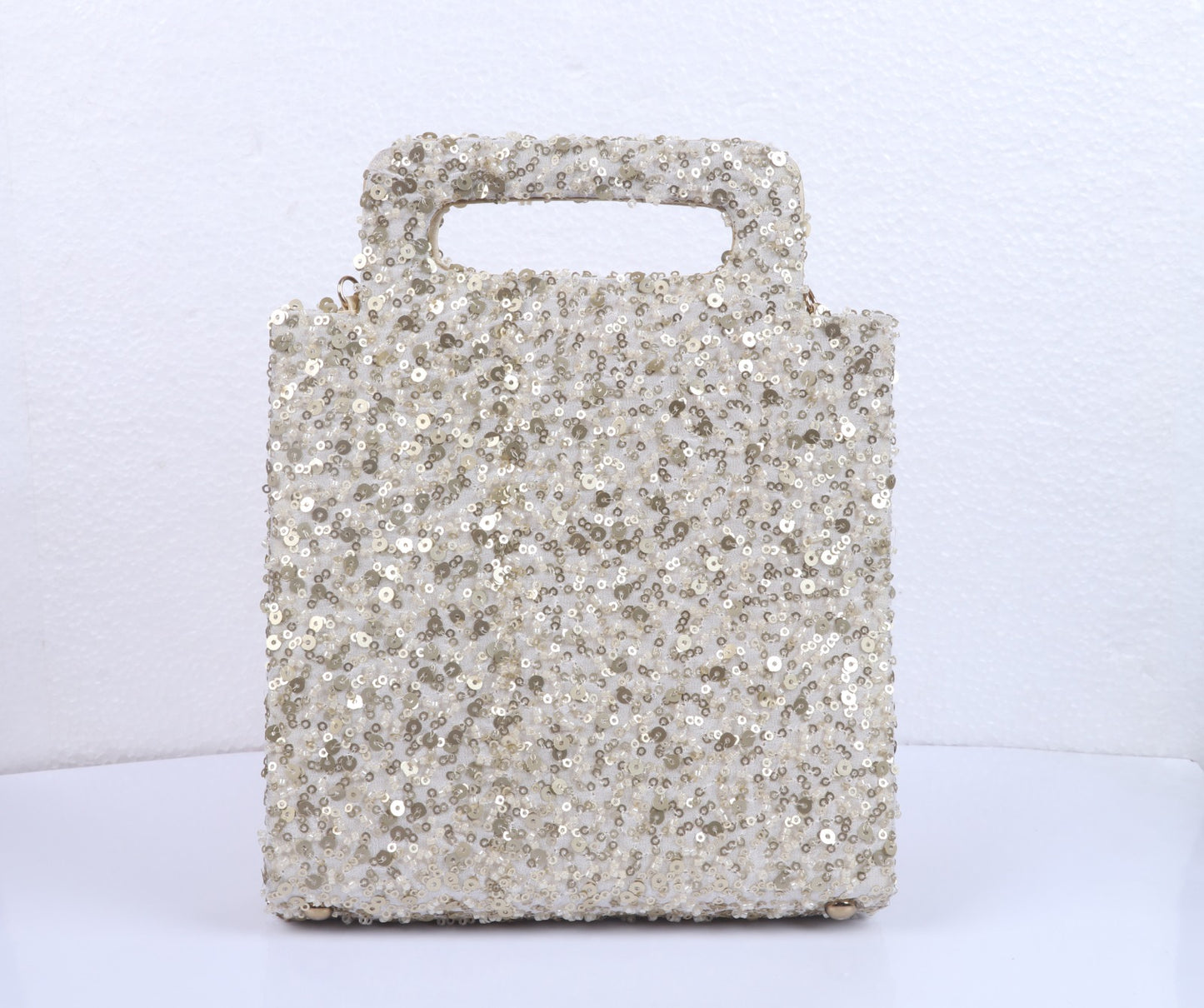 Hand-held shimmer clutch